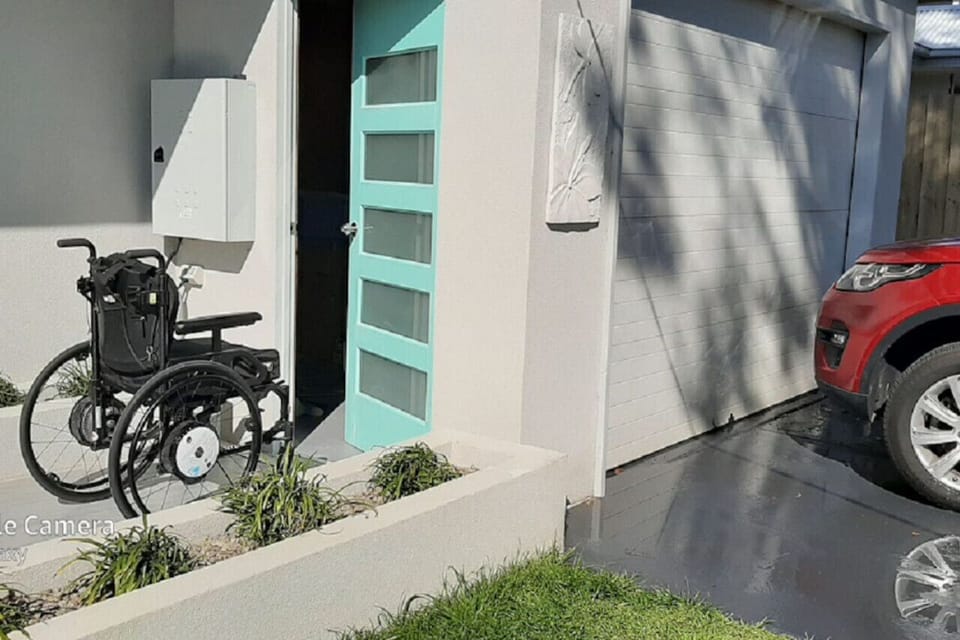 Wheelchair access ramp from the garage to the front entrance door.
