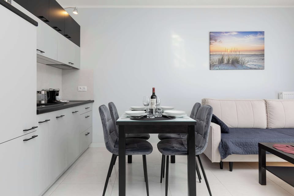 Dining area with a table, chairs, and a kitchenette.