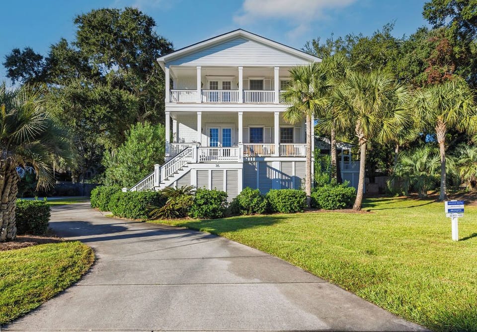 Beautiful coastal home with spacious porches and a welcoming driveway