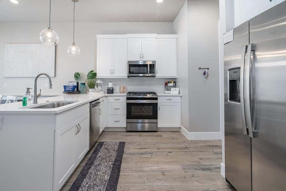 Kitchen has deluxe appliances and space to prepare meals