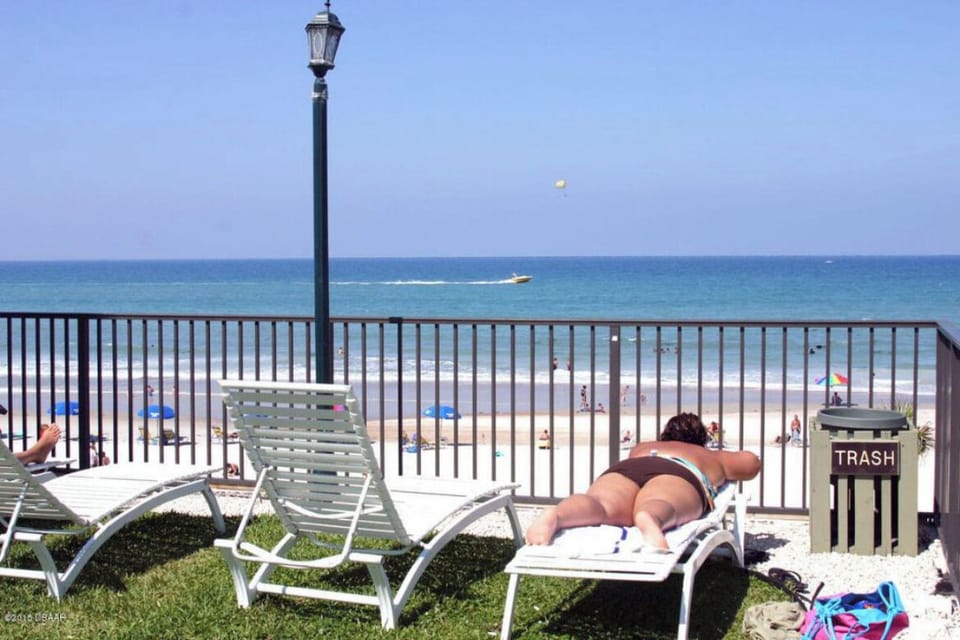 Pool lounge chairs over look the beach 