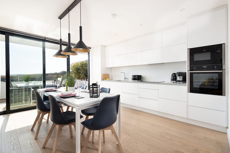3 The Bay, Coldingham - immaculate single-wall kitchen with SMEG appliances and a dining table to seat six