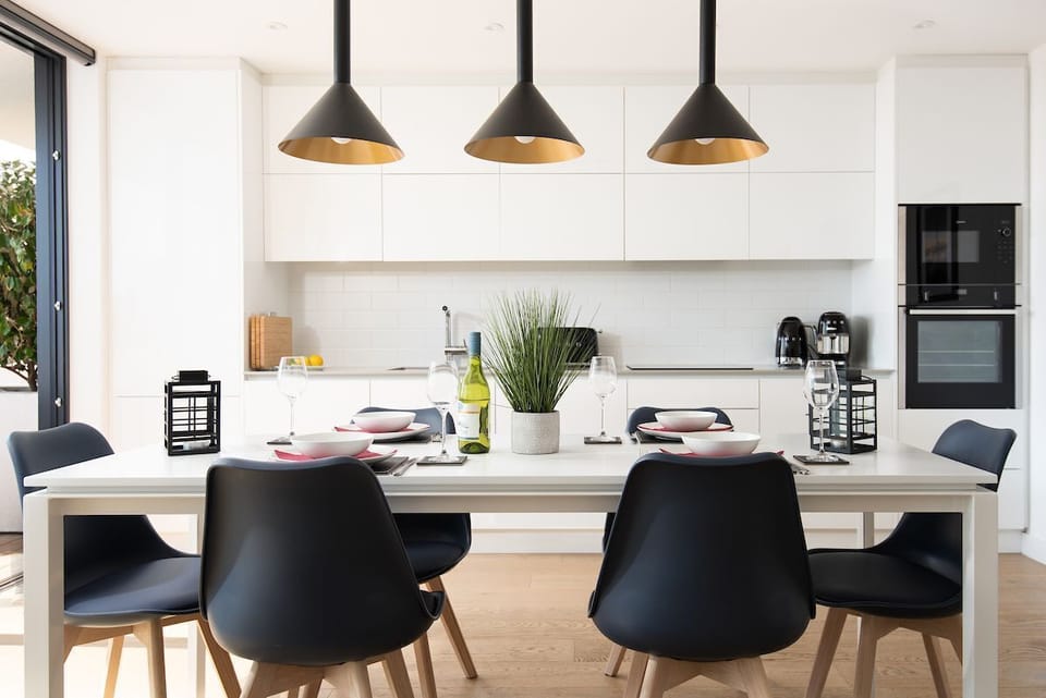 3 The Bay, Coldingham - striking pendant lighting centred over the dining table in this bright living space