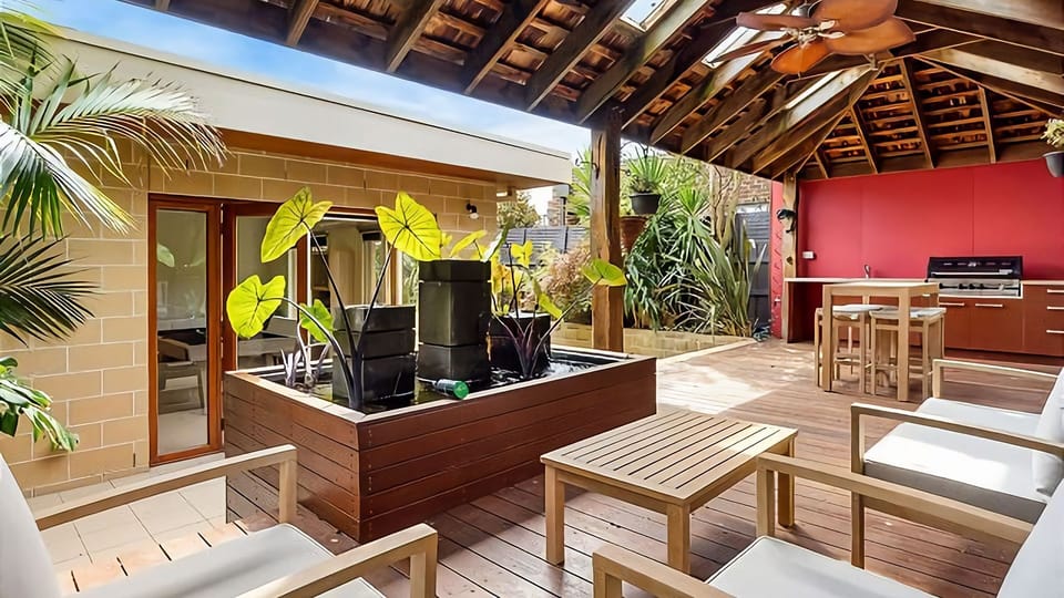 Out the back beneath the enormous timber pergola you'll enjoy a seating area around a pond, an outdoor kitchenette with gas BBQ cooking facilities and high ball table and chairs.