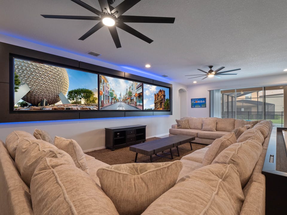 - Relax in the spacious living room with oversized sectional sofa  
- Watch movies on large wall screens with family and friends  
- Vacation home in Orlando offering comfort and entertainment