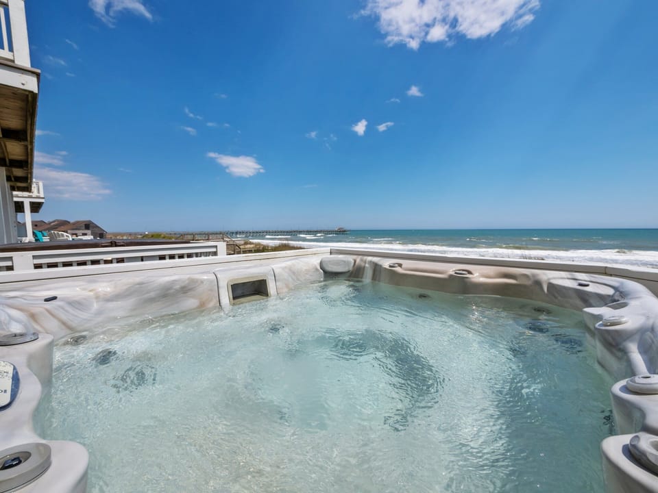 Soak in the hot tub while listening to the waves crash