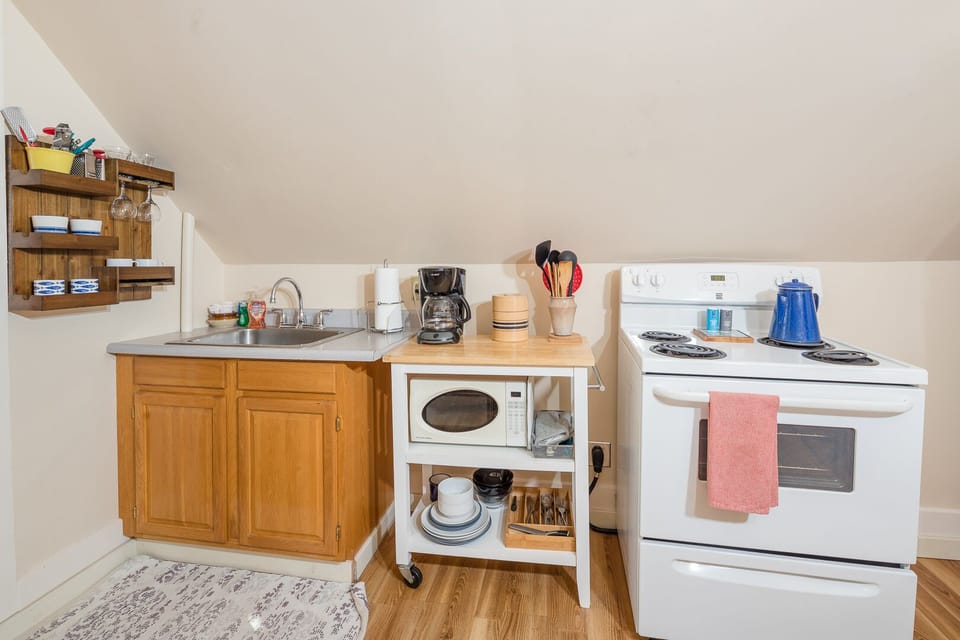 Kitchen complete with electric stove and oven.
