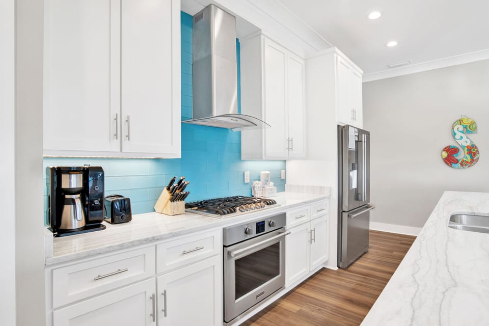 Gorgeous kitchen with stone counters and stainless appliances