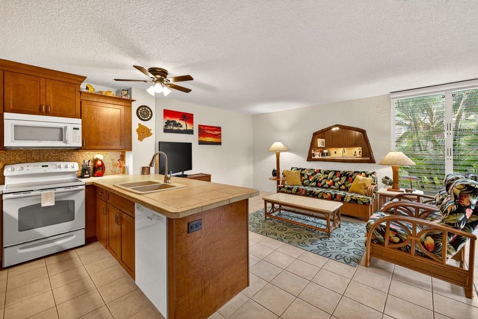 Comfortable island-style living with a fully equipped kitchen, tropical furnishings, and a bright open layout designed for relaxing, cooking, and enjoying time together.