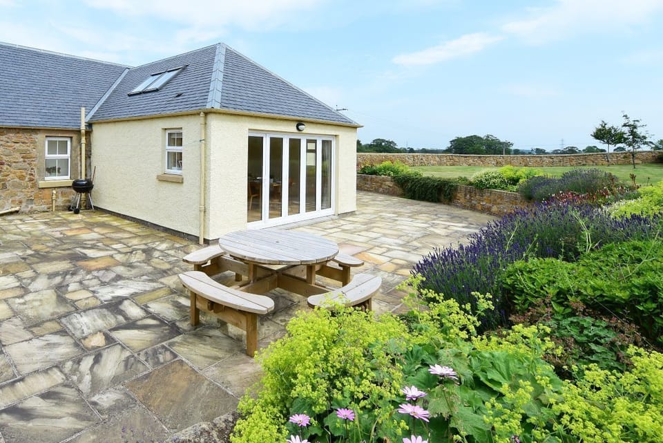 Hawthorn House - outdoor seating for eight on the patio area, accessed from the bi-fold doors of the kitchen