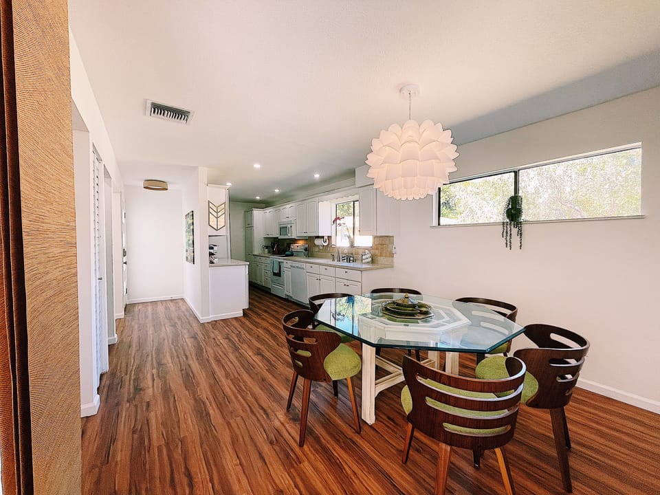Dining room looking into the kitchen with incredible Koa floor