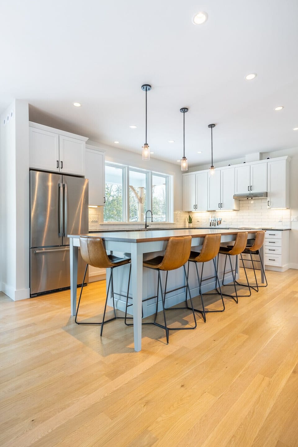Open kitchen with walnut  and granite countertops.