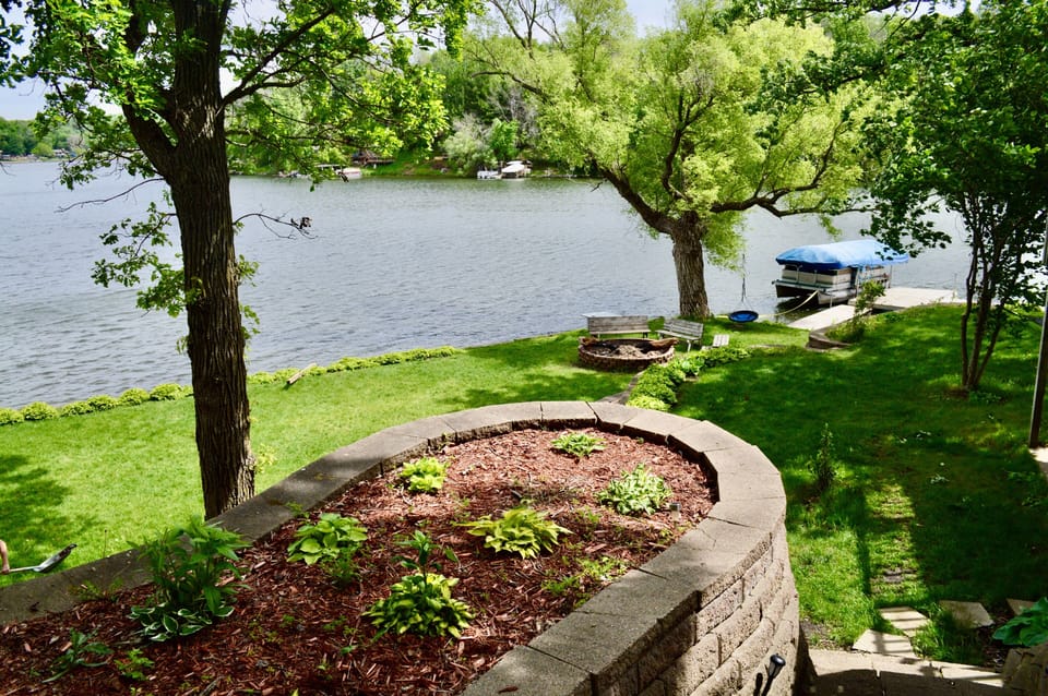 Summer view of the large backyard, shoreline access and lake!!