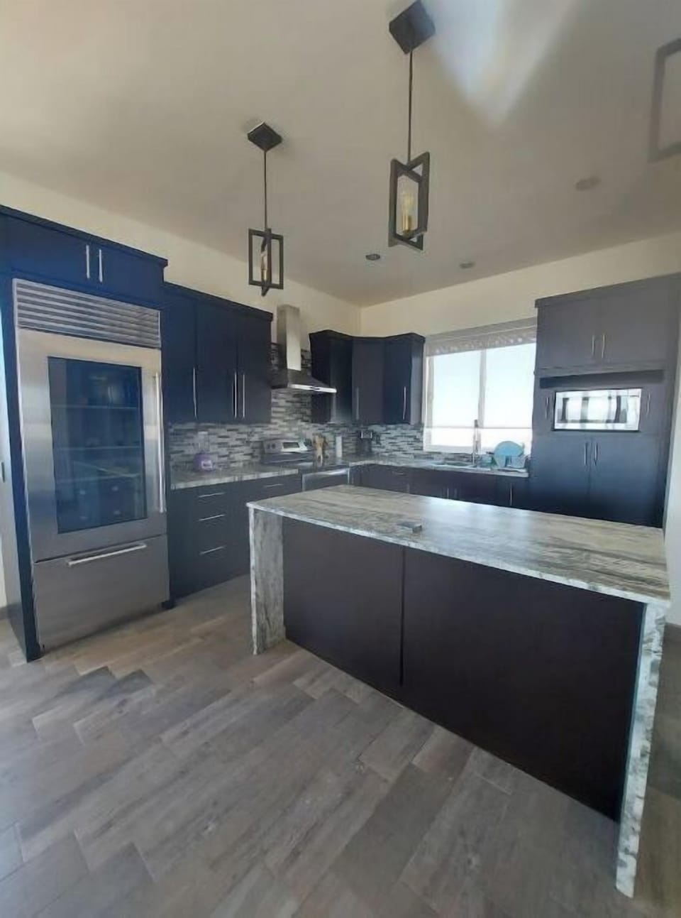 kitchen with kitchen island, microwave, stovetop, dishwasher, fridge, etc. 