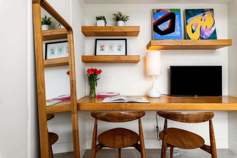 Creative Corner with a Mid-Century Twist 🎨🌿 Designed for comfort and focus, this inviting workspace features warm wood tones, curated decor, and soft lighting—making it the perfect spot to stay productive or simply unwind.