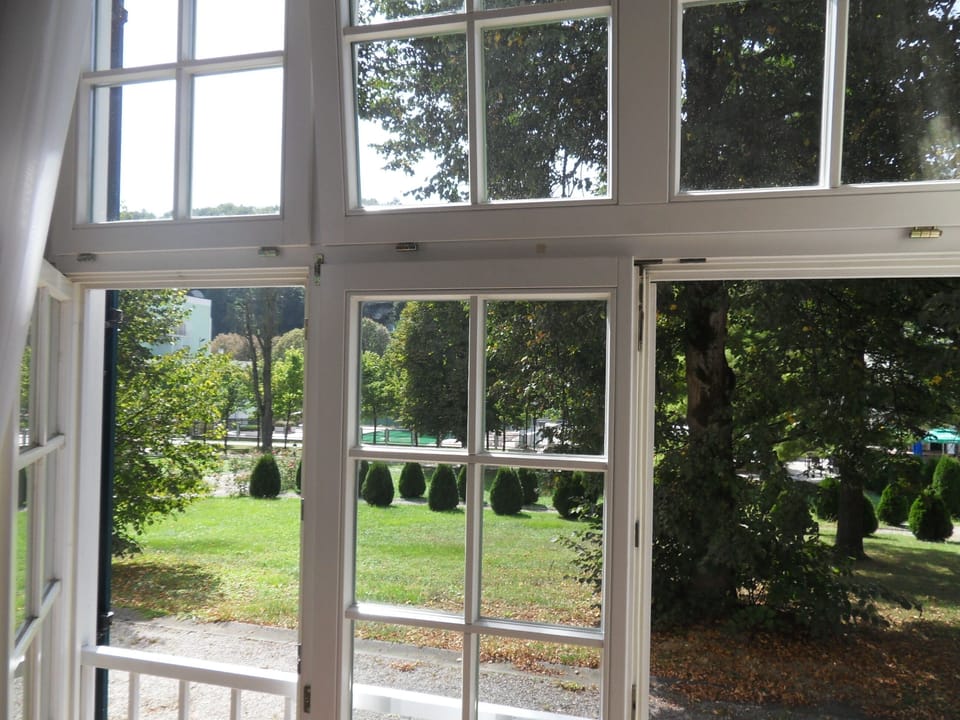 View through panoramic  window on the park and spa with thermal water