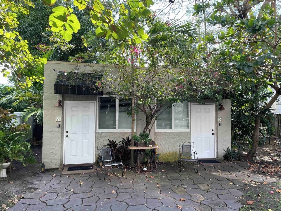 It is in the back of the main house surrounded by a beautiful garden and several areas to sit and enjoy the Miami weather.