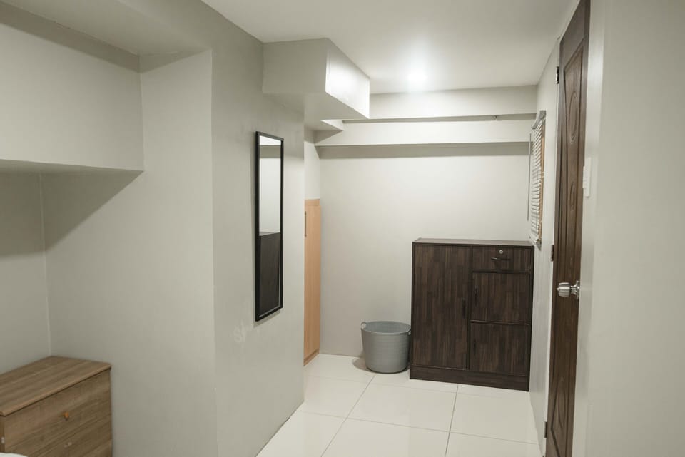 The 2nd bedroom features a mirror, storage closet with safe & a wardrobe.