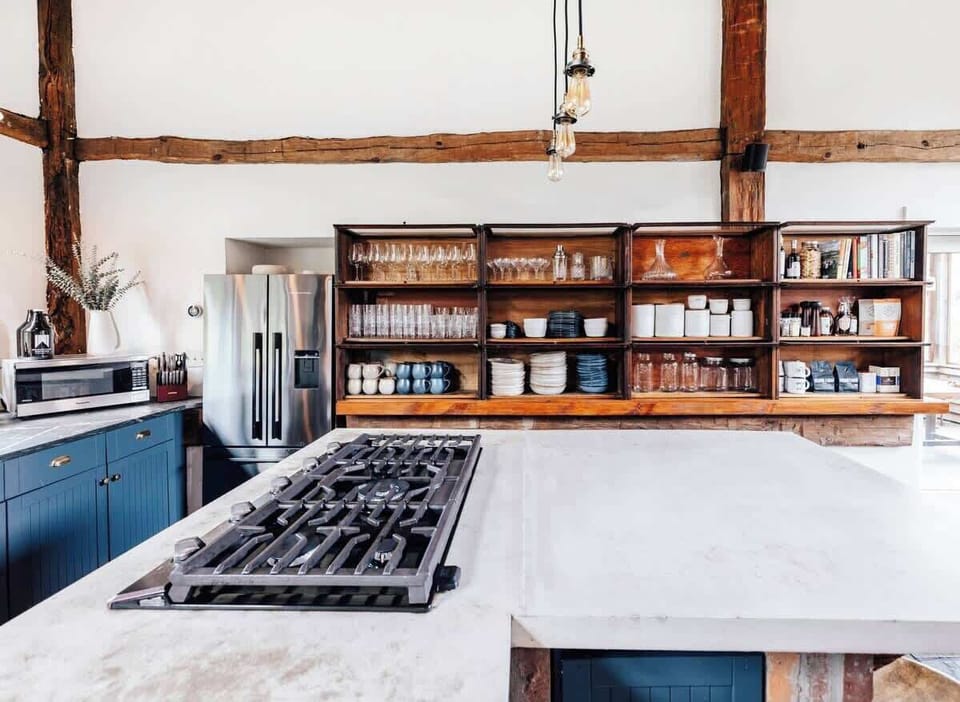 Rustic style, sun-drenched kitchen connecting to a large dine in area. 