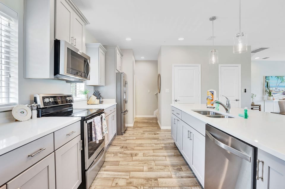 Fully stocked gourmet kitchen with a pantry and a large island.