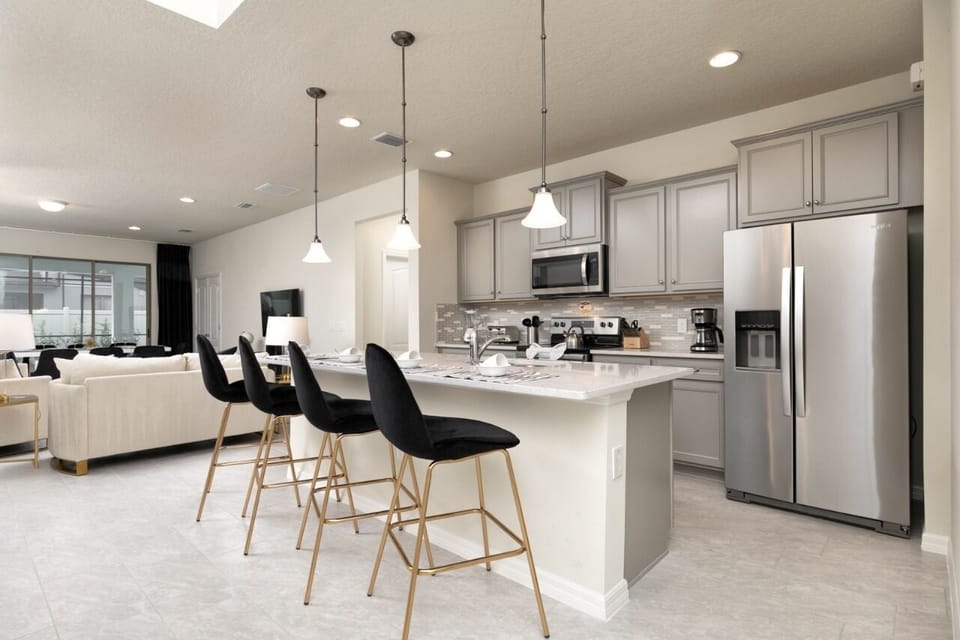 Super equipped kitchen with a beautiful island and 4 stools