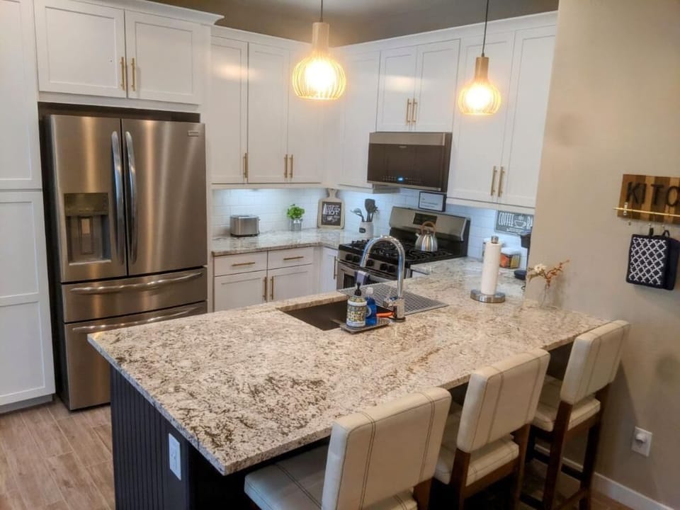 Large granite peninsula with plenty of seating space