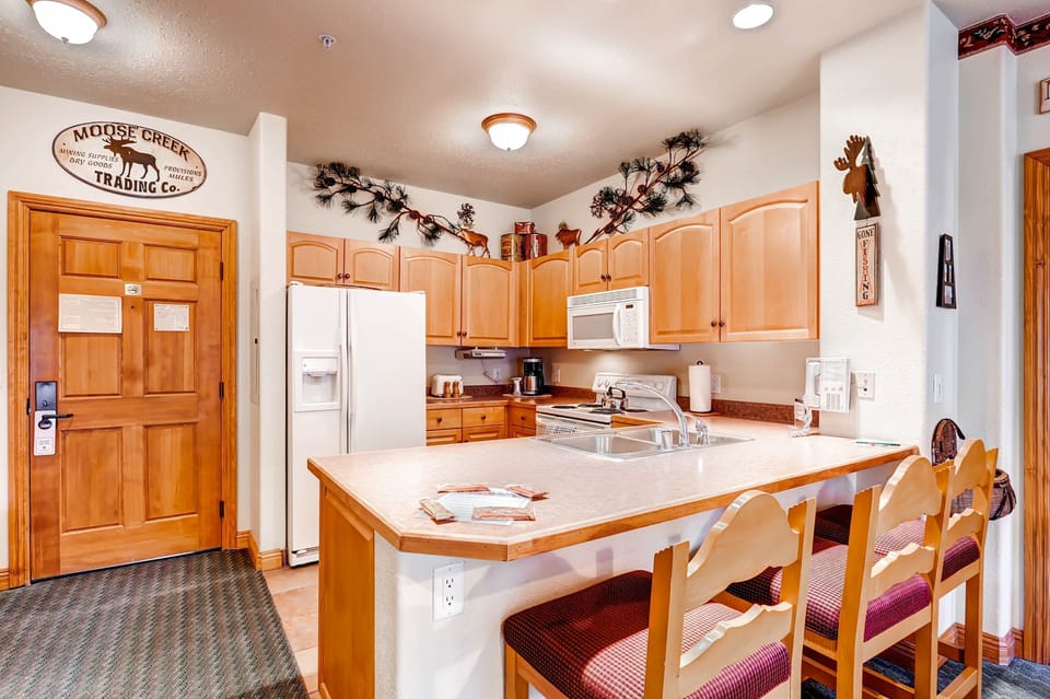 The modern kitchen design incorporates stylish fixtures and ample counter space, while still embracing the cozy mountain lodge feel.