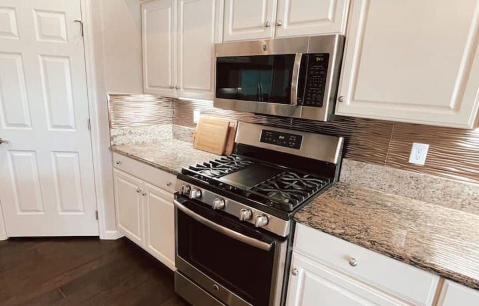 Gas range, large walk in pantry, stocked kitchen with all cooking utensils. 