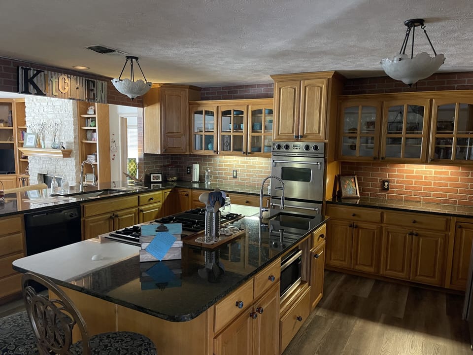 Newly remodeled kitchen, with new countertops, sinks, faucets and new flooring.