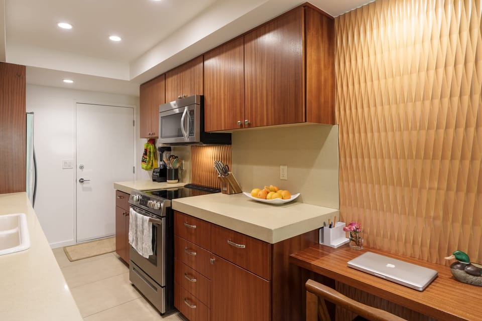 Step into a chef's paradise with this stylish, well-appointed modern kitchen. Featuring stainless steel appliances, sleek countertops, & ample cabinet space, it's the perfect space to cook & gather with family & friends, creating delicious memories!