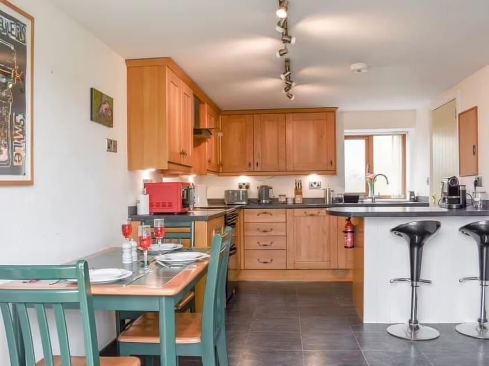 Fully equipped kitchen diner with cooker, fridge, Nespresso machine.