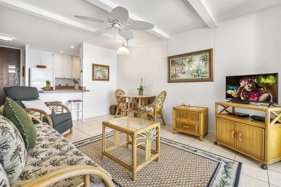 Bright living space with a queen sofa bed and panoramic ocean views — perfect for relaxation.