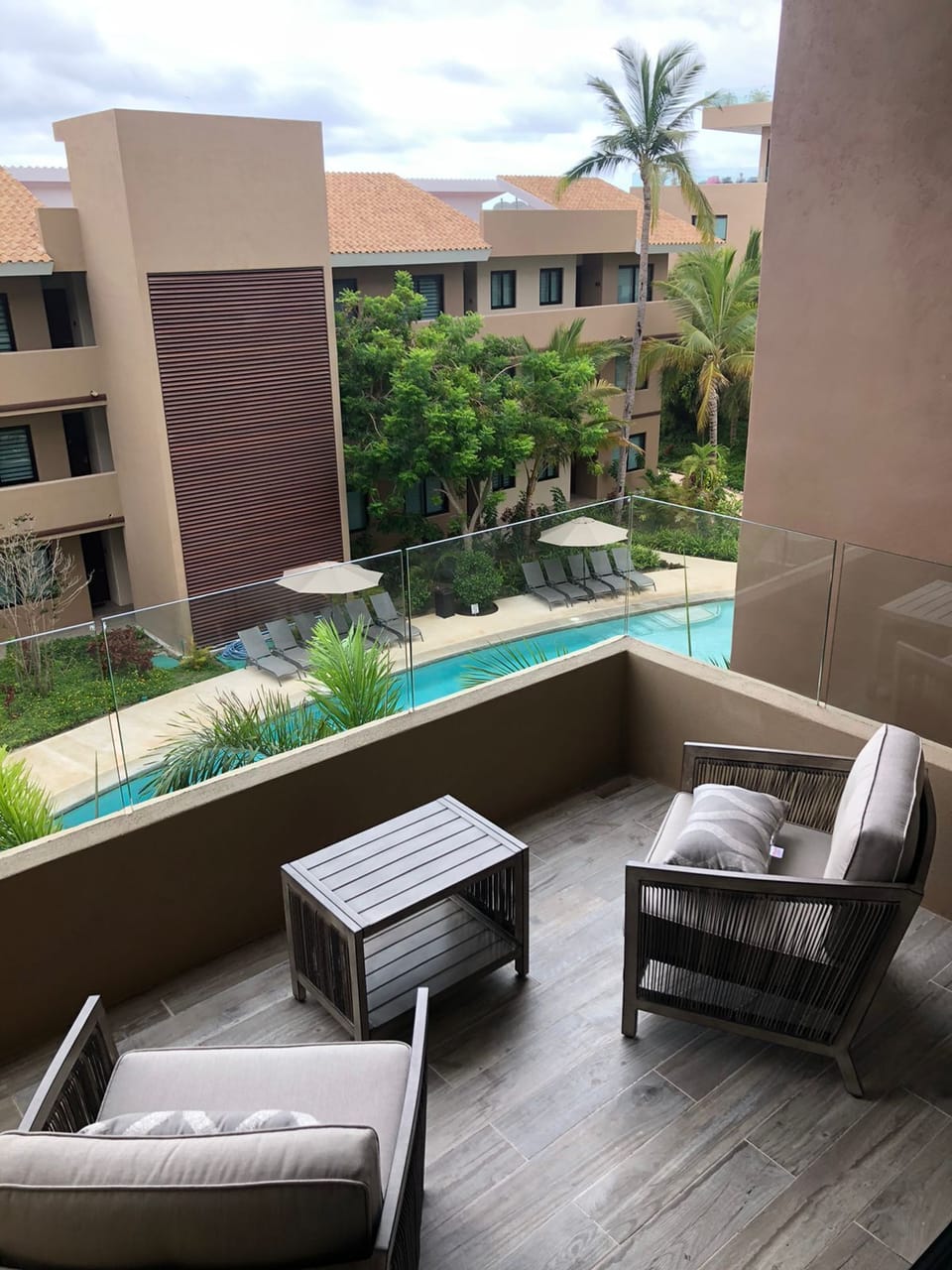 Private deck overlooking pool with limited beach view