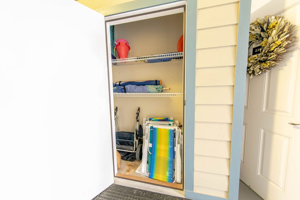 Storage closet holds chairs, beach buggy, & beach toys for guests to enjoy
