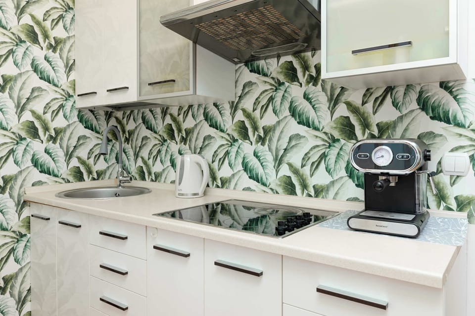 Fully equipped kitchenette with a kettle, electric cooker, fridge freezer, microwave oven and coffee machine.