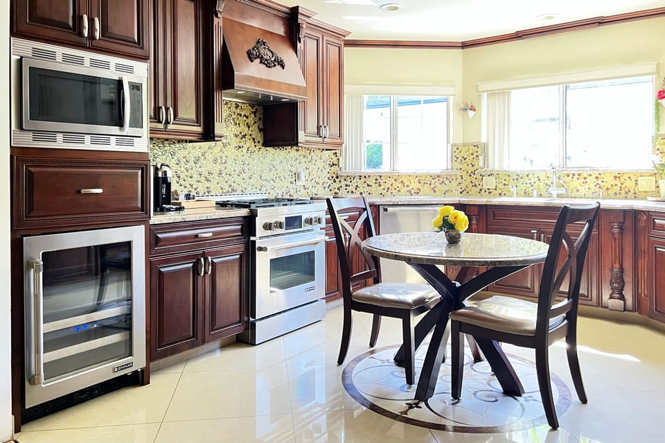 Open concept kitchen with designer finishes and brand appliances.  With pantry.