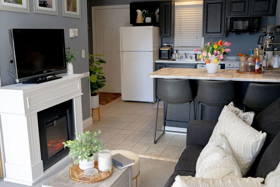 Bright, comfortable sitting area featuring a fireplace and modern touches.