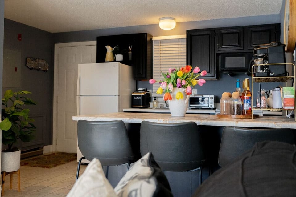Open kitchen with modern appliances and comfortable seating.