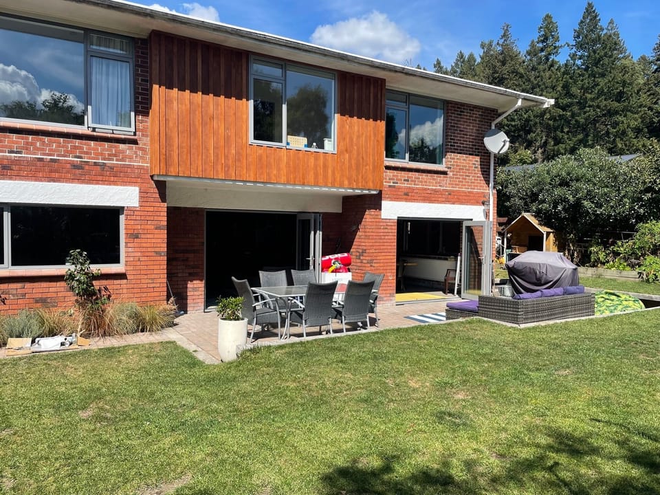 Large back yard with patio and grass area