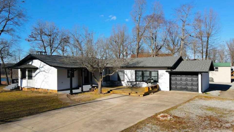 Driveway & kitchen entrance. Large area for parking/playing. Fire pit in back.