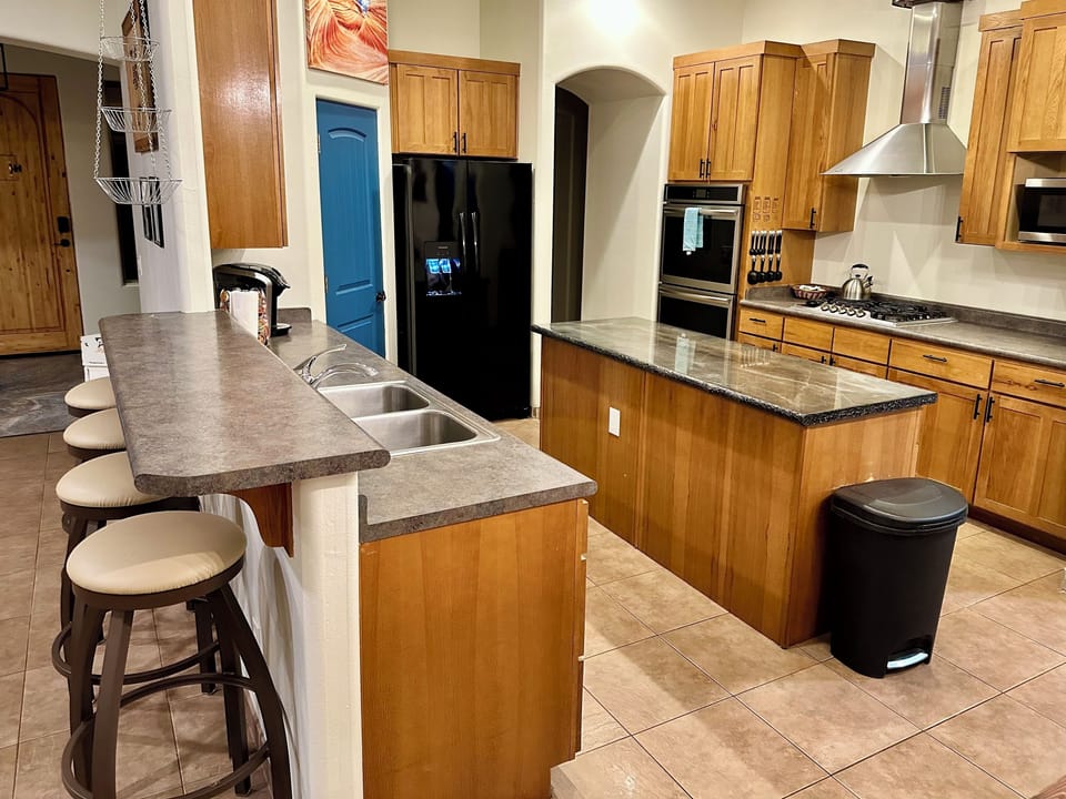 Kitchen, double wall ovens, propane cooktop.