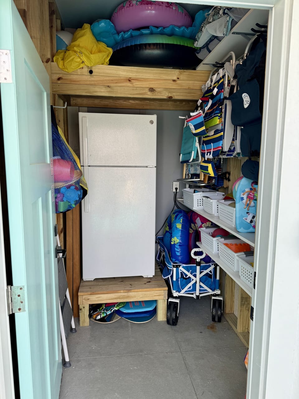 Renter's closet with beach/pool gear plus additional refrigerator