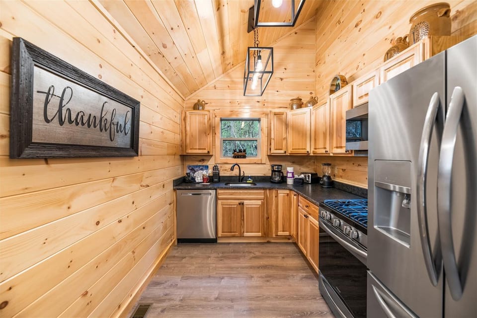 Modern kitchen with leather top granite. Plenty of dishes, untensils, & cookware