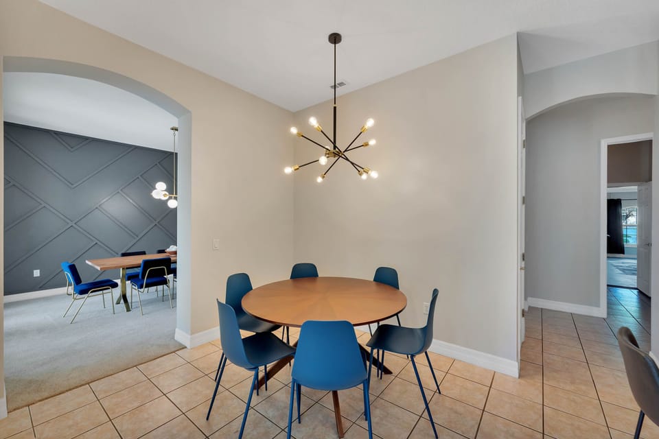 6-person kitchenette table under a bright sputnik chandelier