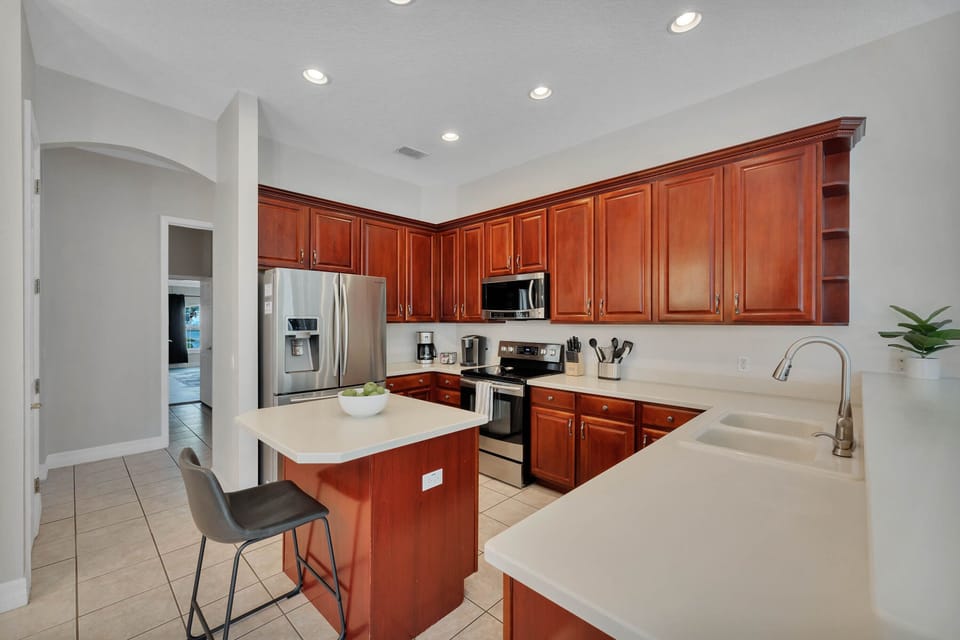 generous kitchen boasts maple cabinets with a cherry finish