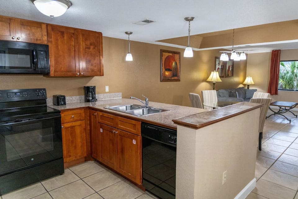 Cook with ease on spacious counters under warm pendant lighting.