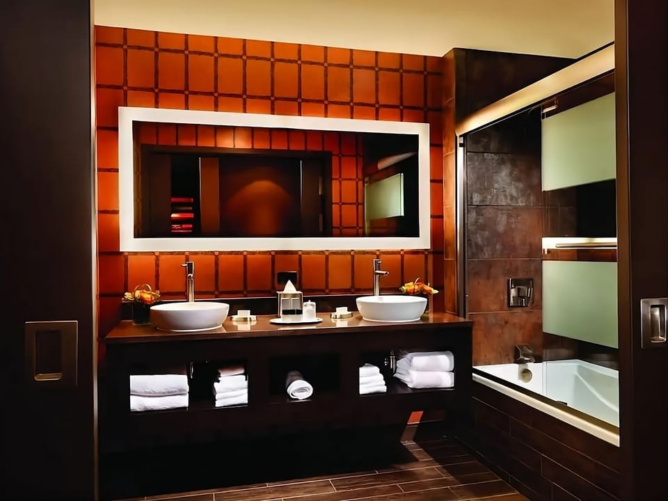 Indulge in a luxe bath with dual sinks and sleek finishes.
