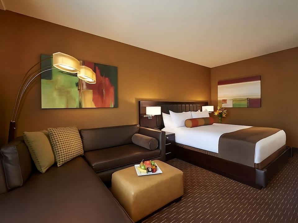 Relax in a stylish suite with inviting seating and plush bed.
