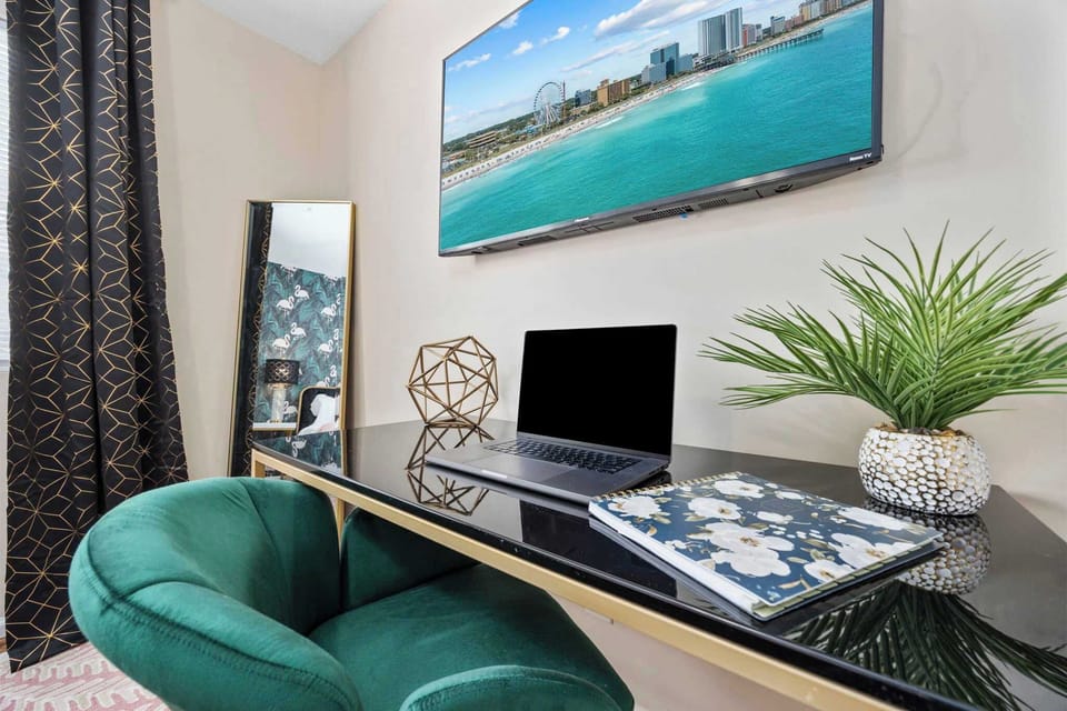 Primary bedroom with king bed, work-from-home desk, smart Roku TV, walk in closet and ensuite bathroom with shower tub.