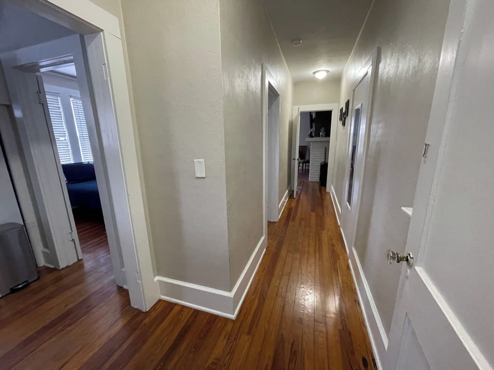 private hall (bathroom behind cameraman) left to kitchen, right to rest